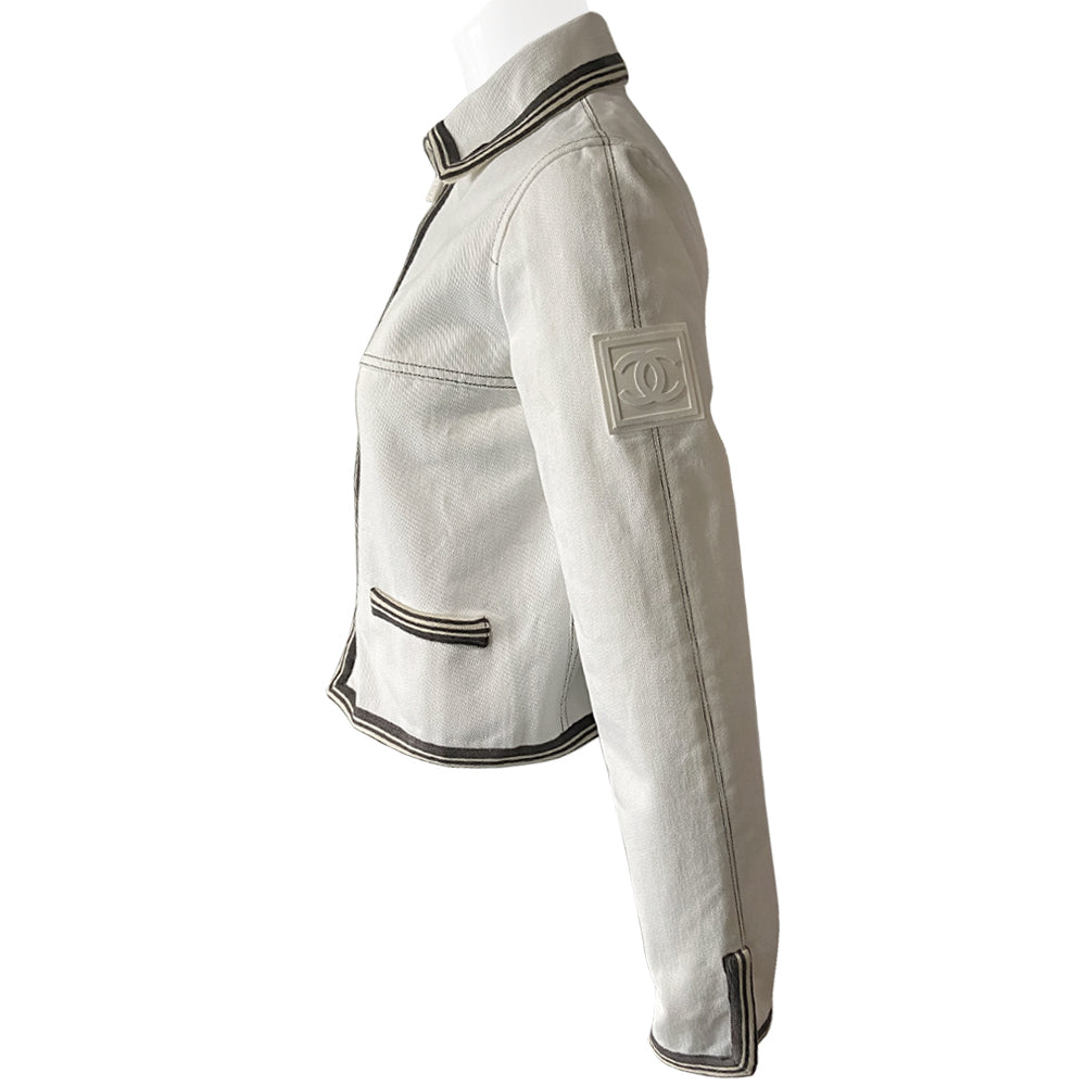 Chanel CC logo white canvas zip jacket by Karl Lagerfeld for Chanel, Cruise 2005 with accent stitching, brown and white striped knit accents, vented detail at sleeve hems. White CC logo zipper pull and white rubber box CC logo appliqué on arm. 100% Cotton