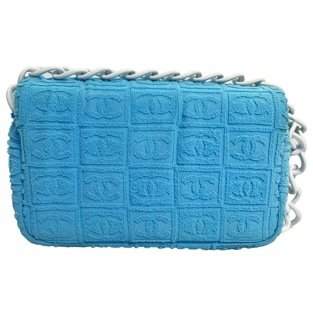 Chanel sky blue blue terry towel flap bag Karl Lagerfeld for Chanel 2002 with all over boxed cc logo embossed terry cloth flap bag with bold white acrylic chain strap, white cc front logo at flap, white zipper closure, white leather lining with one pvc pocket and 1 slip pocket. Made in Italy