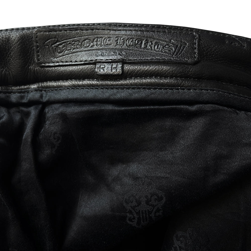 Custom-made unused black leather pants by Chrome Hearts, Los Angeles Front CH appliqué fleur du lis patch at front knees. 5 cross patches, Chrome Hearts jacquard silk lining, 5 sterling silver fly buttons. Three front pockets with sterling grommets, back pocket with sterling Chrome Hearts banner, Interior leather Chrome Hearts USA banner embossed patch.