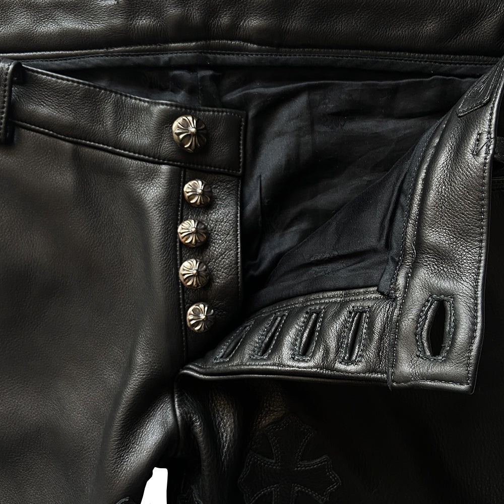 Custom-made unused black leather pants by Chrome Hearts, Los Angeles Front CH appliqué fleur du lis patch at front knees. 5 cross patches, Chrome Hearts jacquard silk lining, 5 sterling silver fly buttons. Three front pockets with sterling grommets, back pocket with sterling Chrome Hearts banner, Interior leather Chrome Hearts USA banner embossed patch.