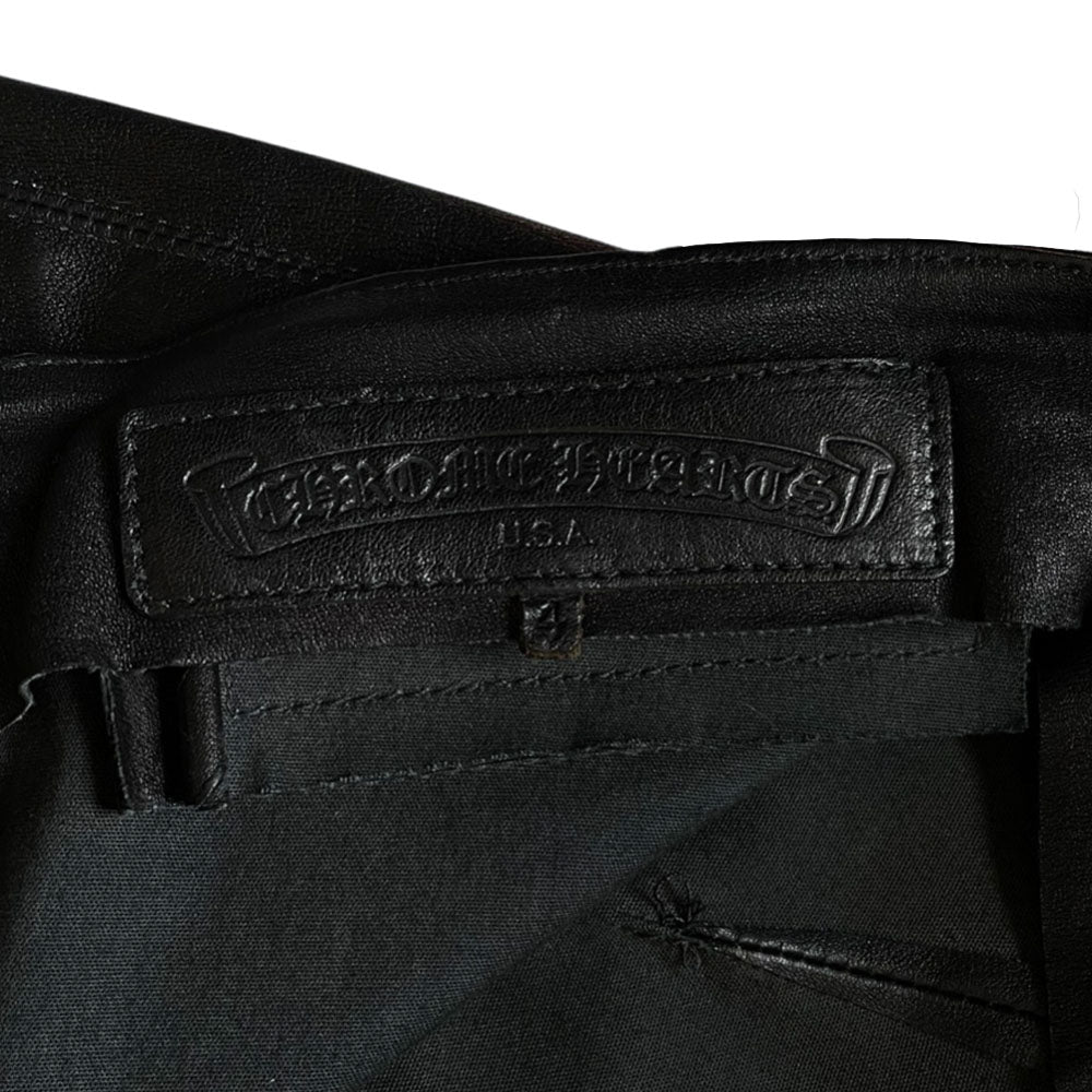 Butter soft women’s boot cut leather pants with CH appliqué signature fleur de lis at front knees. Faux front slash pockets, zip fly closure with signature dagger zipper pull and sterling cross top button. Chrome Hearts USA banner embossed leather patch at interior waist. Made in USA