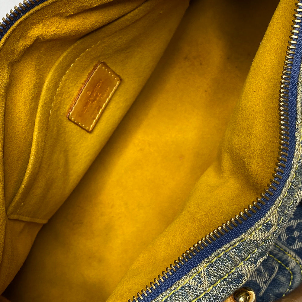Louis Vuitton monogram blue denim neo speedy by Marc Jacobs for Louis Vuitton, 2005 with 2 outer front pockets with gold-tone push lock closures and hardware. Vachetta leather trimmed exterior, zippered outer pocket, 2 rolled leather handles. Top zip closure opens to alcantara lining with one interior slip pocket. Made in France