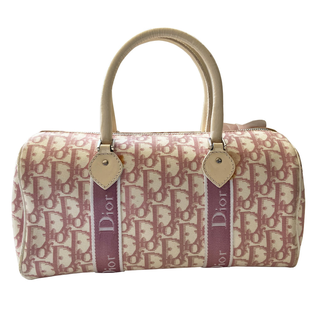 Christian Dior pink Girly Boston bag by John Galliano for Dior, 2004. Crystal front Dior logo and patent leather No. 1 with crystals, 2 logo ribbon straps, white leather flowers with pearl centres. White patent leather rolled top handles, top zipper, crystal encrusted lock. Pink textile interior, 1 inside zip pocket. Made in Italy