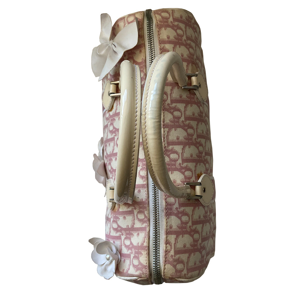 Christian Dior pink Girly Boston bag by John Galliano for Dior, 2004. Crystal front Dior logo and patent leather No. 1 with crystals, 2 logo ribbon straps, white leather flowers with pearl centres. White patent leather rolled top handles, top zipper, crystal encrusted lock. Pink textile interior, 1 inside zip pocket. Made in Italy