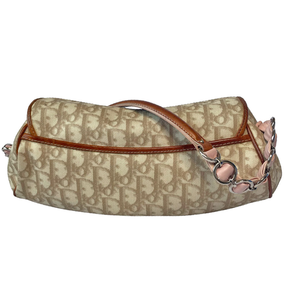 Christian Dior beige monogram coated canvas small shoulder bag by John Galliano for Dior, 2007 with brown leather piping, magnetic front flap, brown leather & pink leather bow detail with Dior logo embossed pink leather covered hanging heart. Blush rose satin lining, one zipper pocket. Pink leather woven through silver tone chain with brown leather strap. Made in Italy