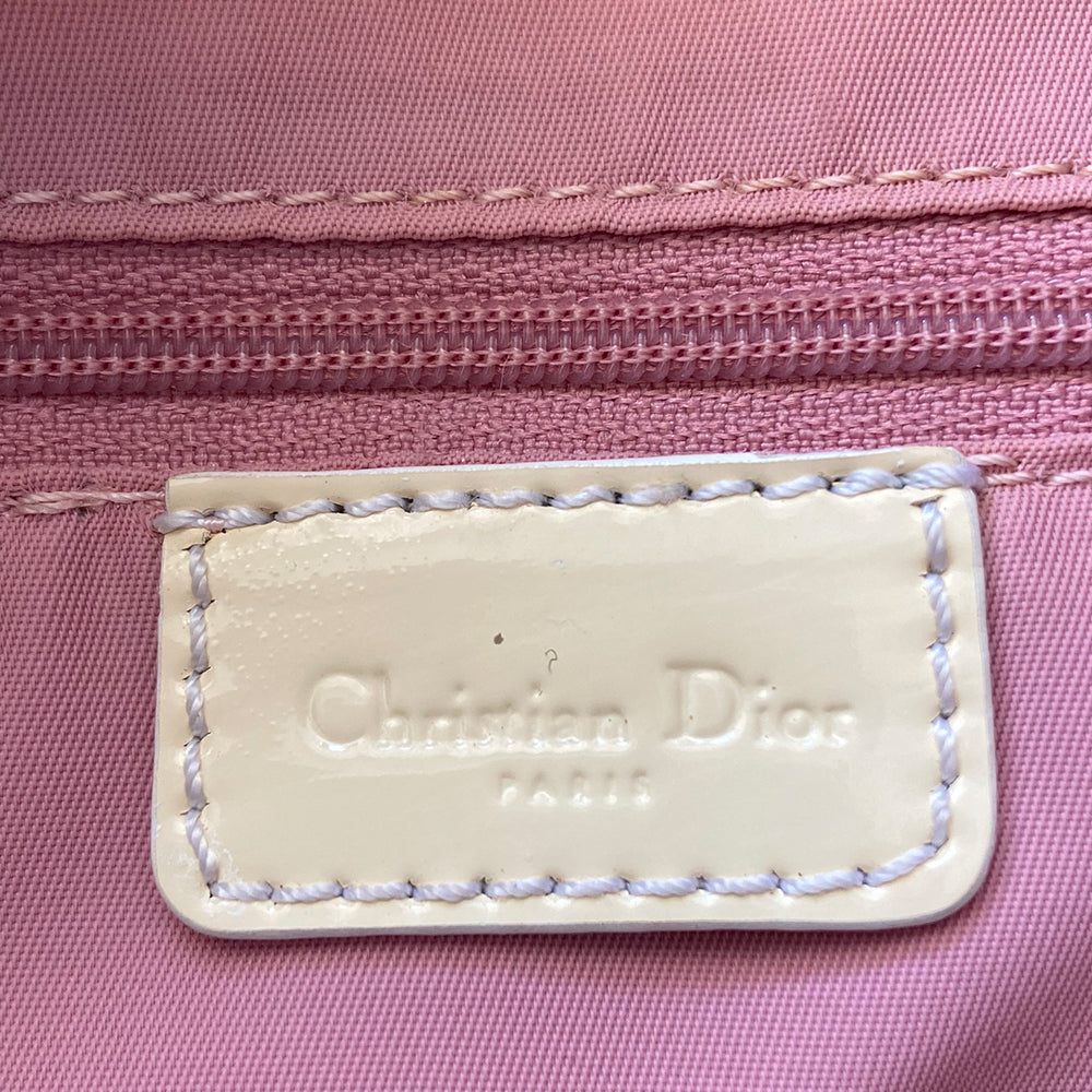Christian Dior pink Girly Boston bag by John Galliano for Dior, 2004. Crystal front Dior logo and patent leather No. 1 with crystals, 2 logo ribbon straps, white leather flowers with pearl centres. White patent leather rolled top handles, top zipper, crystal encrusted lock. Pink textile interior, 1 inside zip pocket. Made in Italy