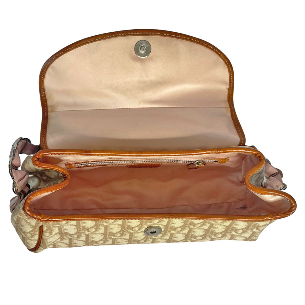 Christian Dior beige monogram coated canvas small shoulder bag by John Galliano for Dior, 2007 with brown leather piping, magnetic front flap, brown leather & pink leather bow detail with Dior logo embossed pink leather covered hanging heart. Blush rose satin lining, one zipper pocket. Pink leather woven through silver tone chain with brown leather strap. Made in Italy