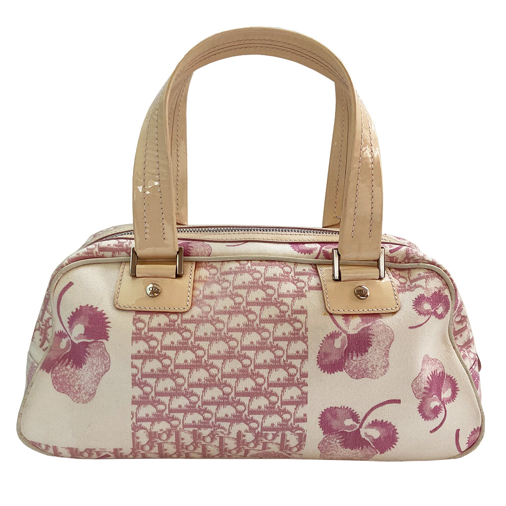 Christian Dior cherry blossom boston bag by John Galliano for Dior from 2004 Logo Flowers Collection. Pink flowers and monogram print canvas with patent calfskin handles and accent, silver hardware and zipper. Outside front pocket with Dior logo and front metal loop clasp. Pink with cream patent accent, pink textile interior with single zip pocket.