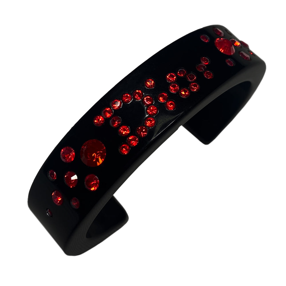 Christian Dior narrow black acrylic cuff with Dior spelled out in brilliant red crystals. with original box.