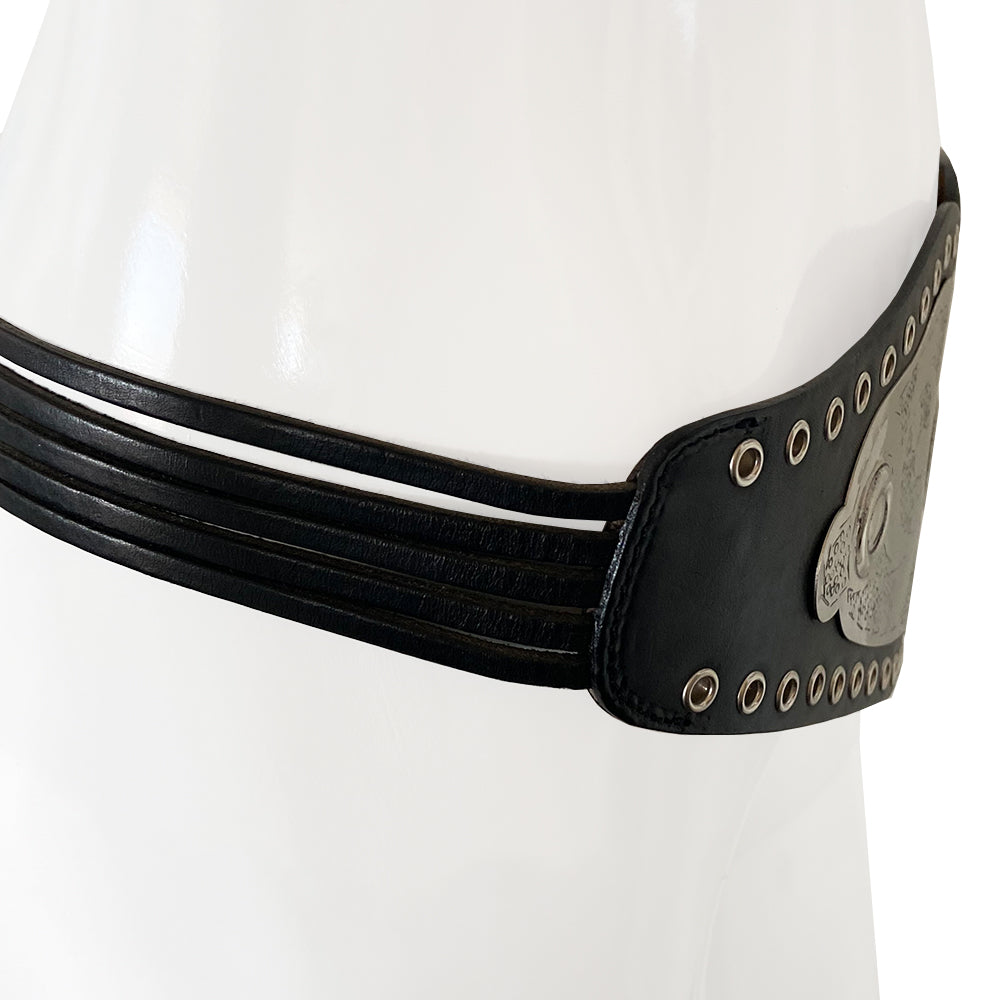 Christian Dior Championship Belt from fall 2001 RTW runway collection by John Galliano. Black leather belt with eyelets surrounding the large embossed silver-tone engraved metal plate with CD logo at center. Leather strands connect to end pieces with silver-tone CD engraved buckle with 6 adjustment holes. Made in Italy