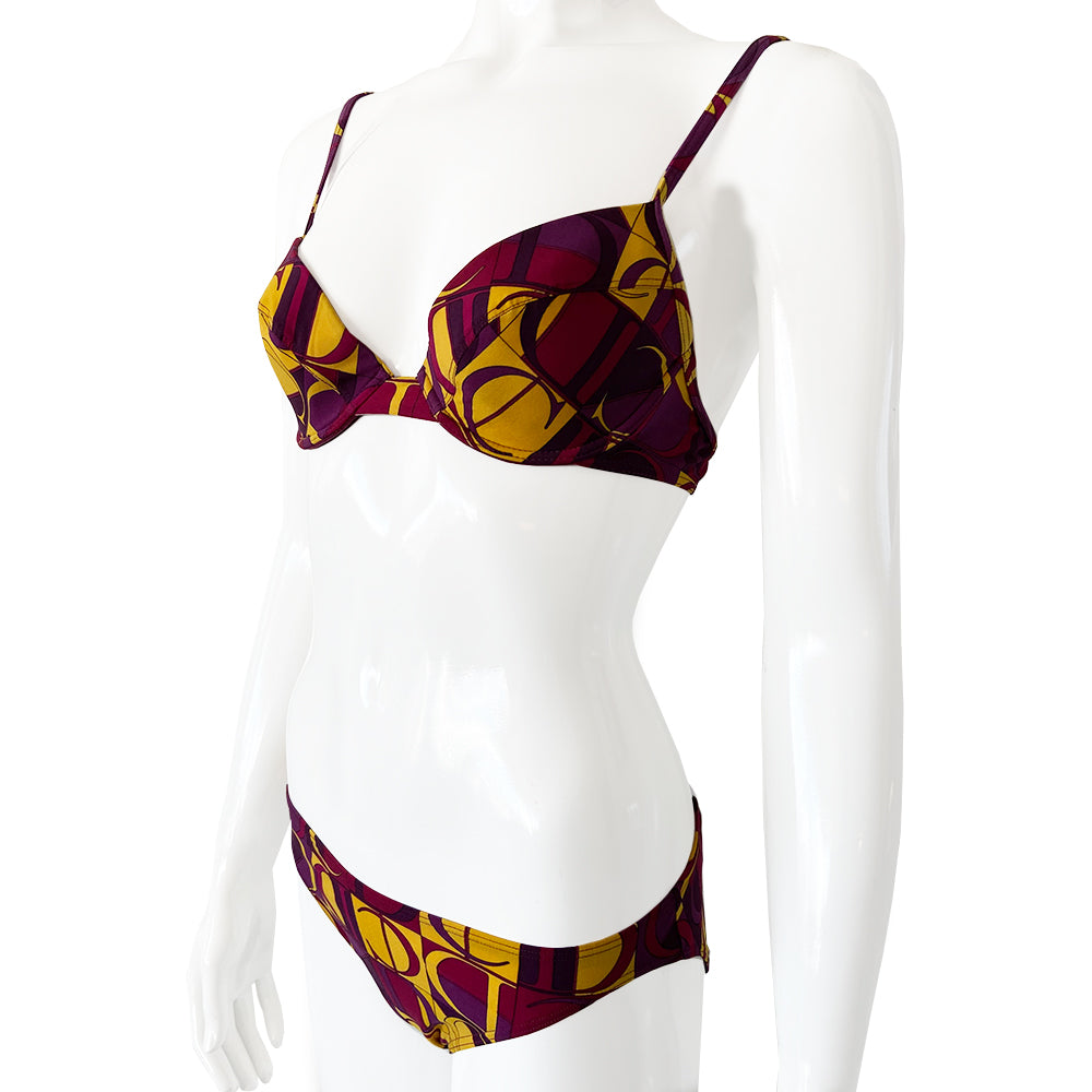 Christian Dior Purple and Yellow CD Logo Bikini with mid rise bottoms and all over modern CD logo print in purple and yellow. Molded bra cups with underwire Gold CD logo clasp closure in back, non-adjustable stretch straps. Made in France