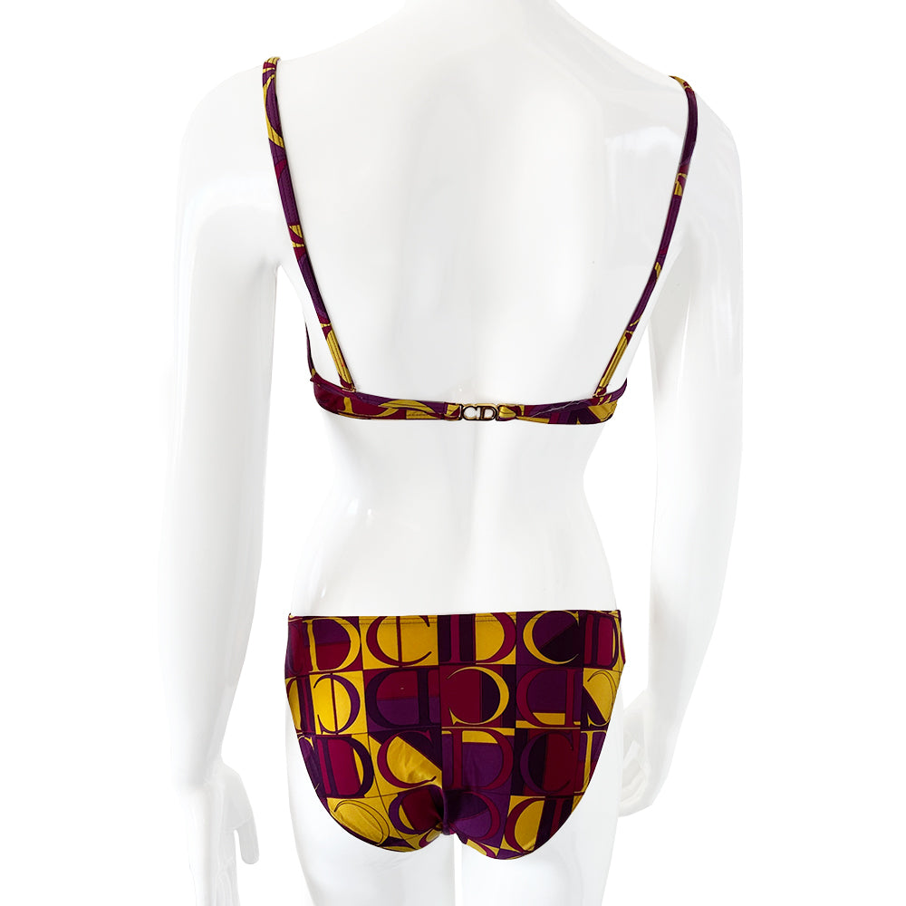 Christian Dior Purple and Yellow CD Logo Bikini with mid rise bottoms and all over modern CD logo print in purple and yellow. Molded bra cups with underwire Gold CD logo clasp closure in back, non-adjustable stretch straps. Made in France