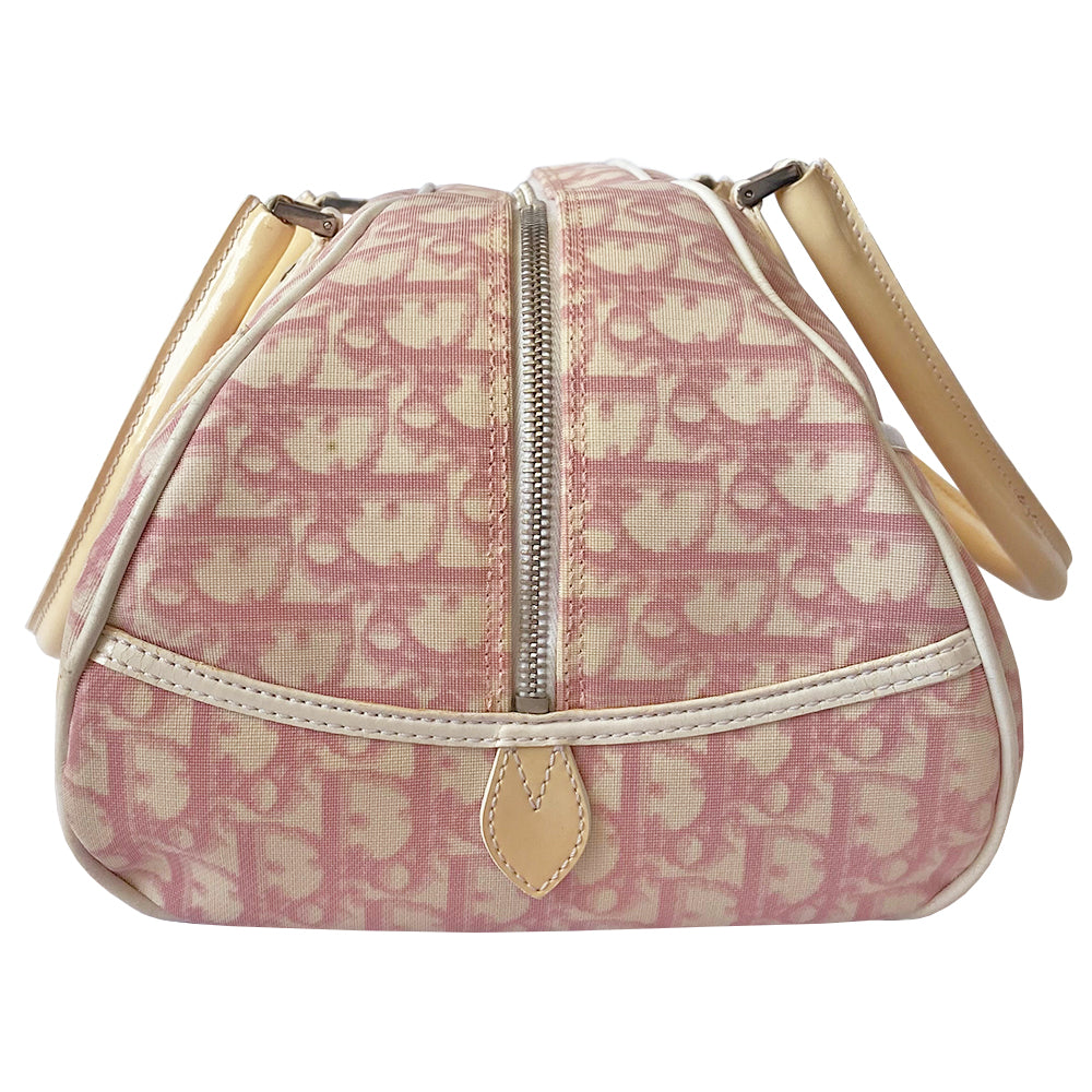Christian Dior large pink monogram canvas boston by John Galliano for Dior, 2004 with white leather piping, cream patent leather accent trim, rolled handles and zipper pull, silver-tone hardware and feet. 2 exterior open pockets with leather accent, pink textile interior with one interior zip pocket, 2 slip pockets.
