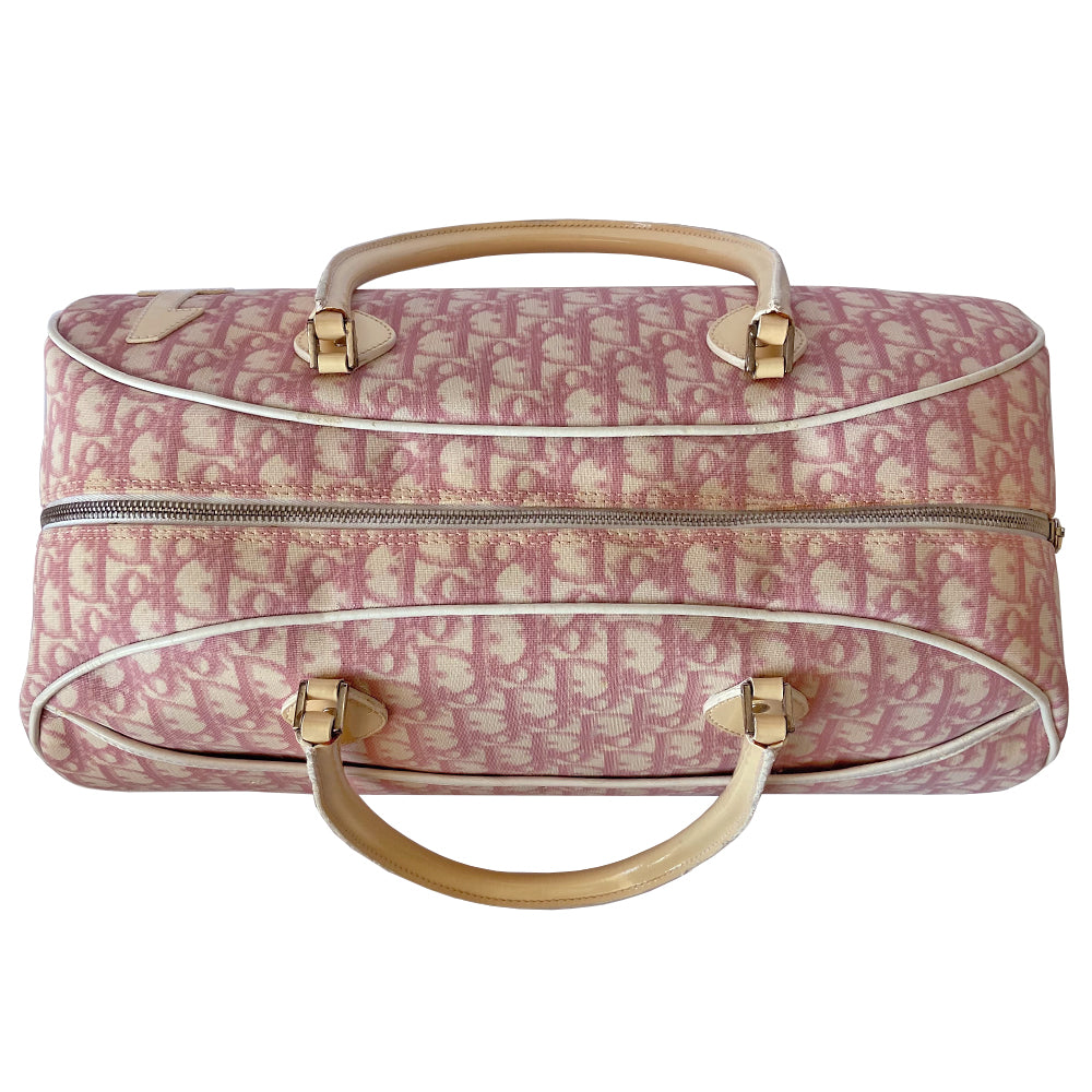 Christian Dior large pink monogram canvas boston by John Galliano for Dior, 2004 with white leather piping, cream patent leather accent trim, rolled handles and zipper pull, silver-tone hardware and feet. 2 exterior open pockets with leather accent, pink textile interior with one interior zip pocket, 2 slip pockets.