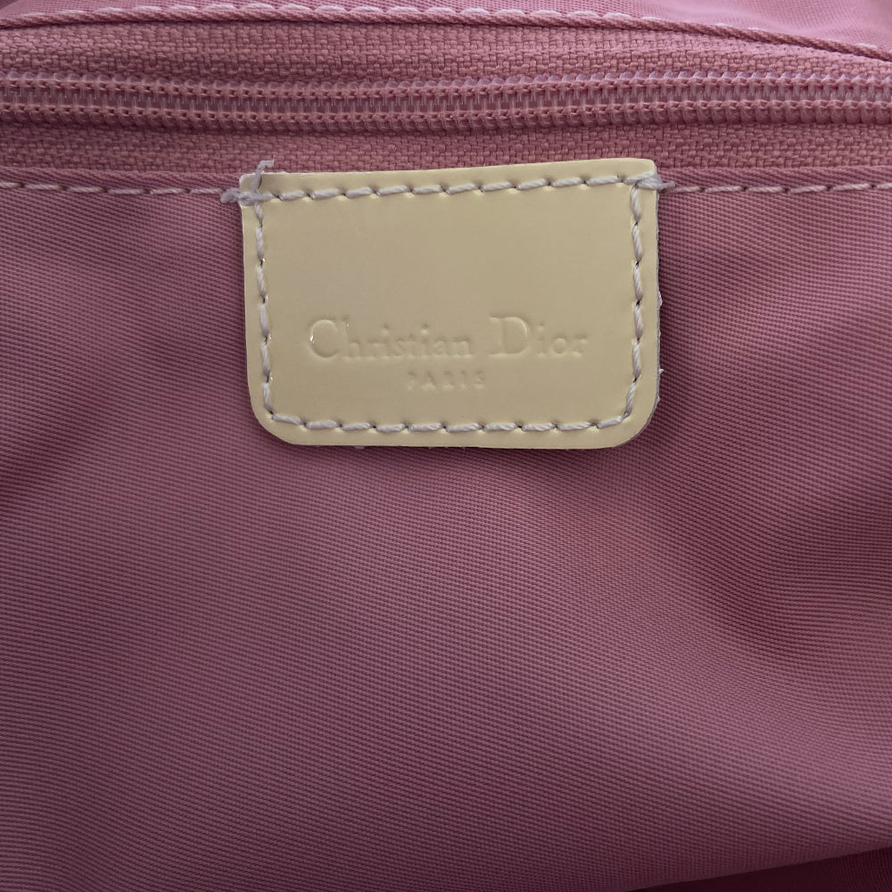 Christian Dior large pink monogram canvas boston by John Galliano for Dior, 2004 with white leather piping, cream patent leather accent trim, rolled handles and zipper pull, silver-tone hardware and feet. 2 exterior open pockets with leather accent, pink textile interior with one interior zip pocket, 2 slip pockets.