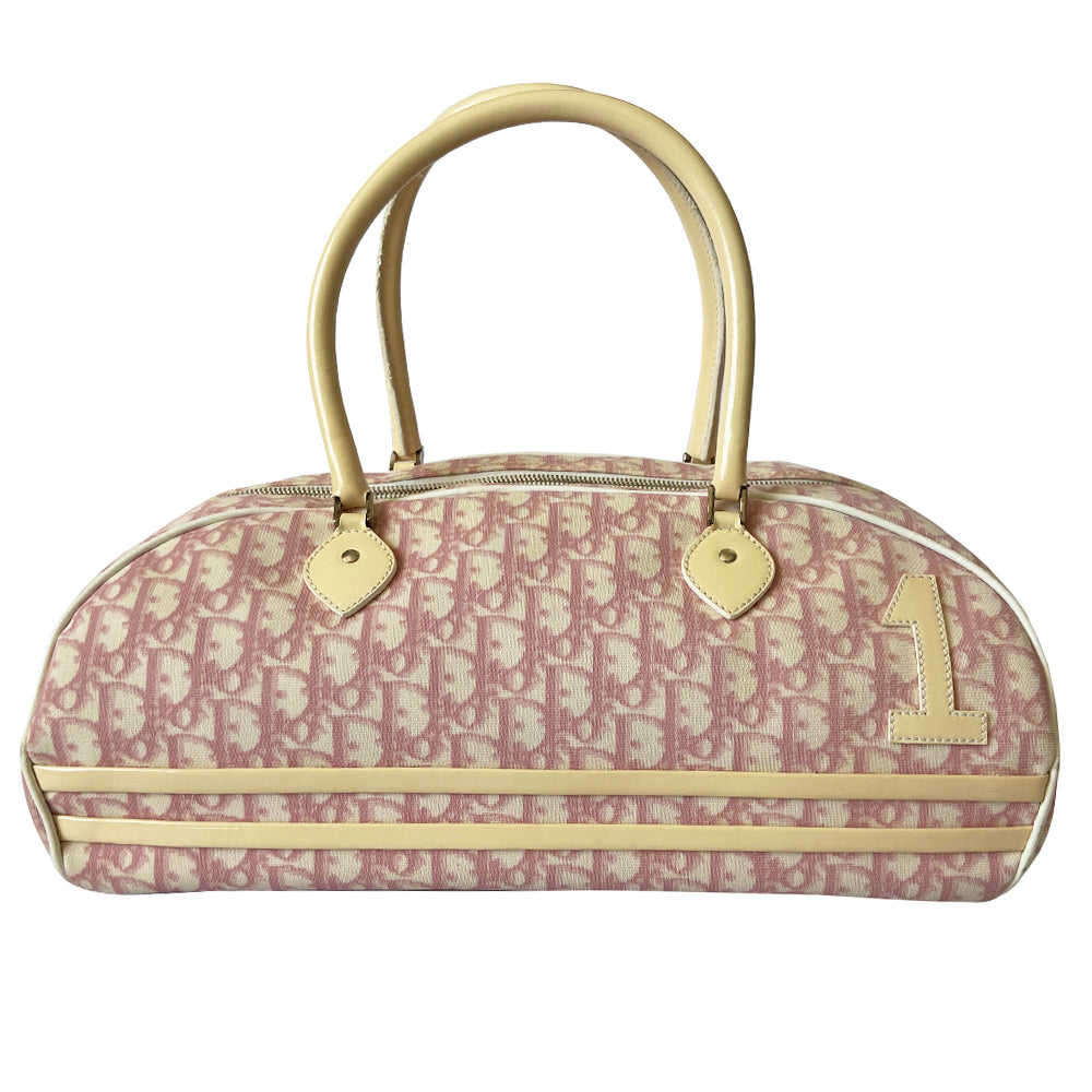 Christian Dior large pink monogram canvas boston by John Galliano for Dior, 2004 with white leather piping, cream patent leather accent trim, rolled handles and zipper pull, silver-tone hardware and feet. 2 exterior open pockets with leather accent, pink textile interior with one interior zip pocket, 2 slip pockets.