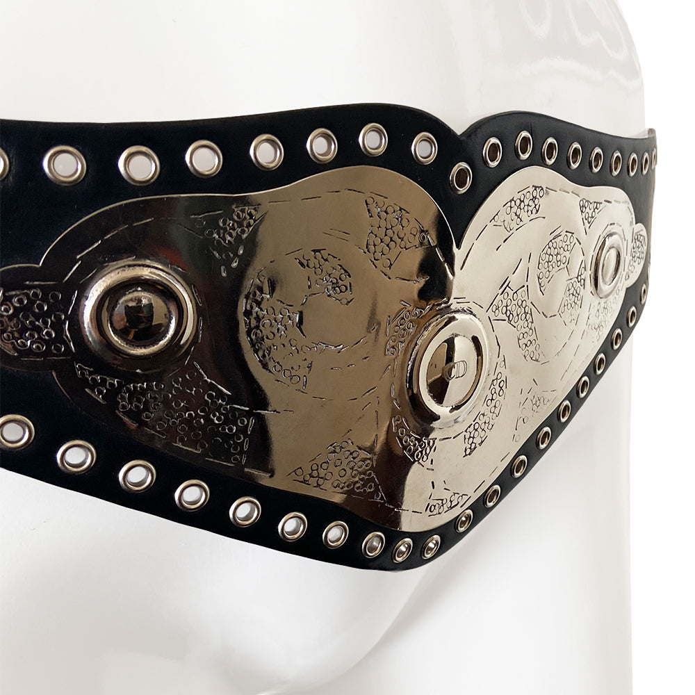 Christian Dior Championship Belt from fall 2001 RTW runway collection by John Galliano. Black leather belt with eyelets surrounding the large embossed silver-tone engraved metal plate with CD logo at center. Leather strands connect to end pieces with silver-tone CD engraved buckle with 6 adjustment holes. Made in Italy