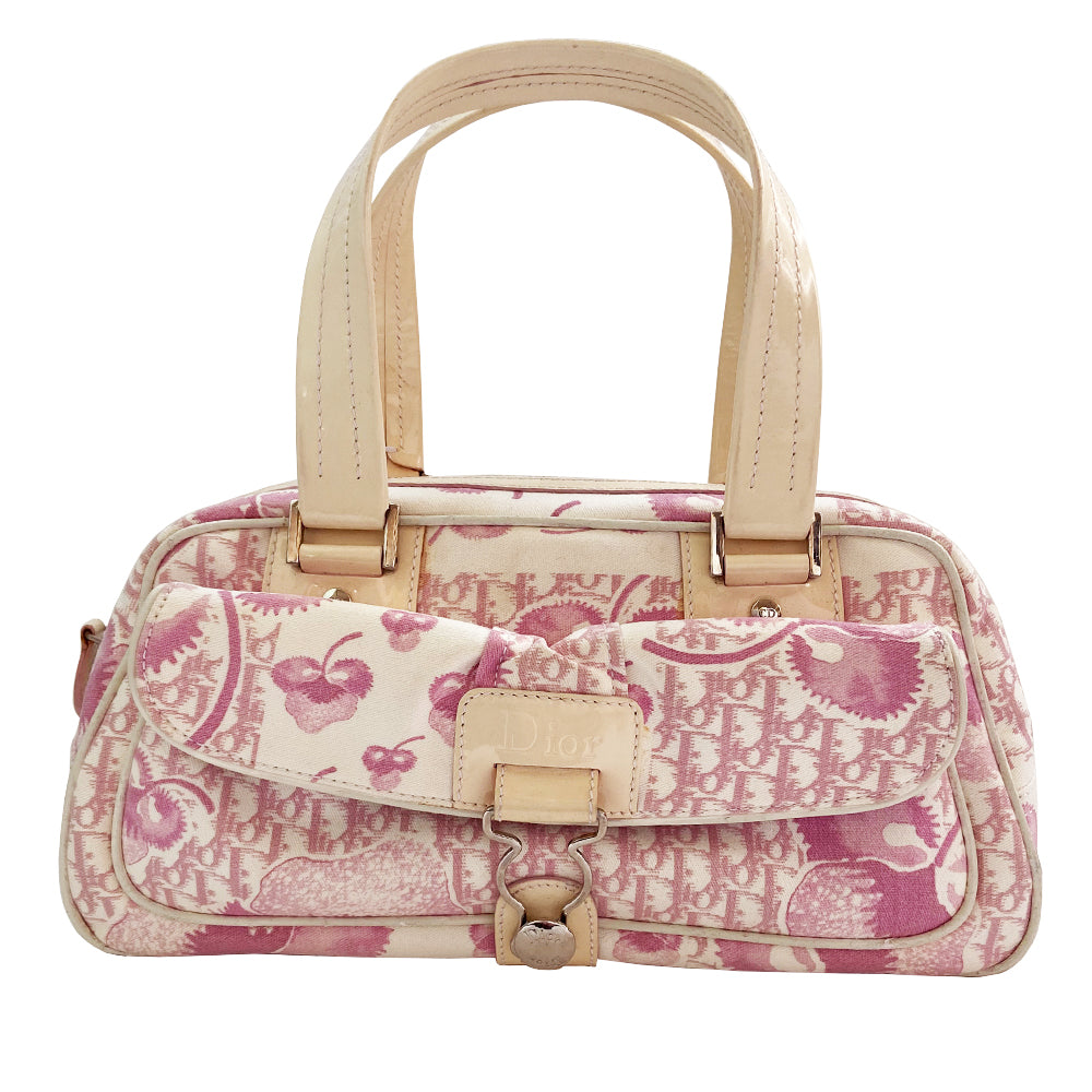 Christian Dior cherry blossom boston bag by John Galliano for Dior from 2004 Logo Flowers Collection. Pink flowers and monogram print canvas with patent calfskin handles and accent, silver hardware and zipper. Outside front pocket with Dior logo and front metal loop clasp. Pink with cream patent accent, pink textile interior with single zip pocket.