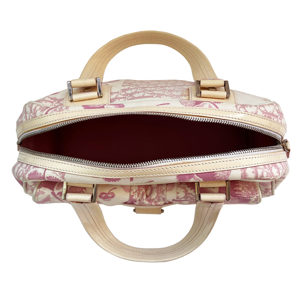 Christian Dior cherry blossom boston bag by John Galliano for Dior from 2004 Logo Flowers Collection. Pink flowers and monogram print canvas with patent calfskin handles and accent, silver hardware and zipper. Outside front pocket with Dior logo and front metal loop clasp. Pink with cream patent accent, pink textile interior with single zip pocket.