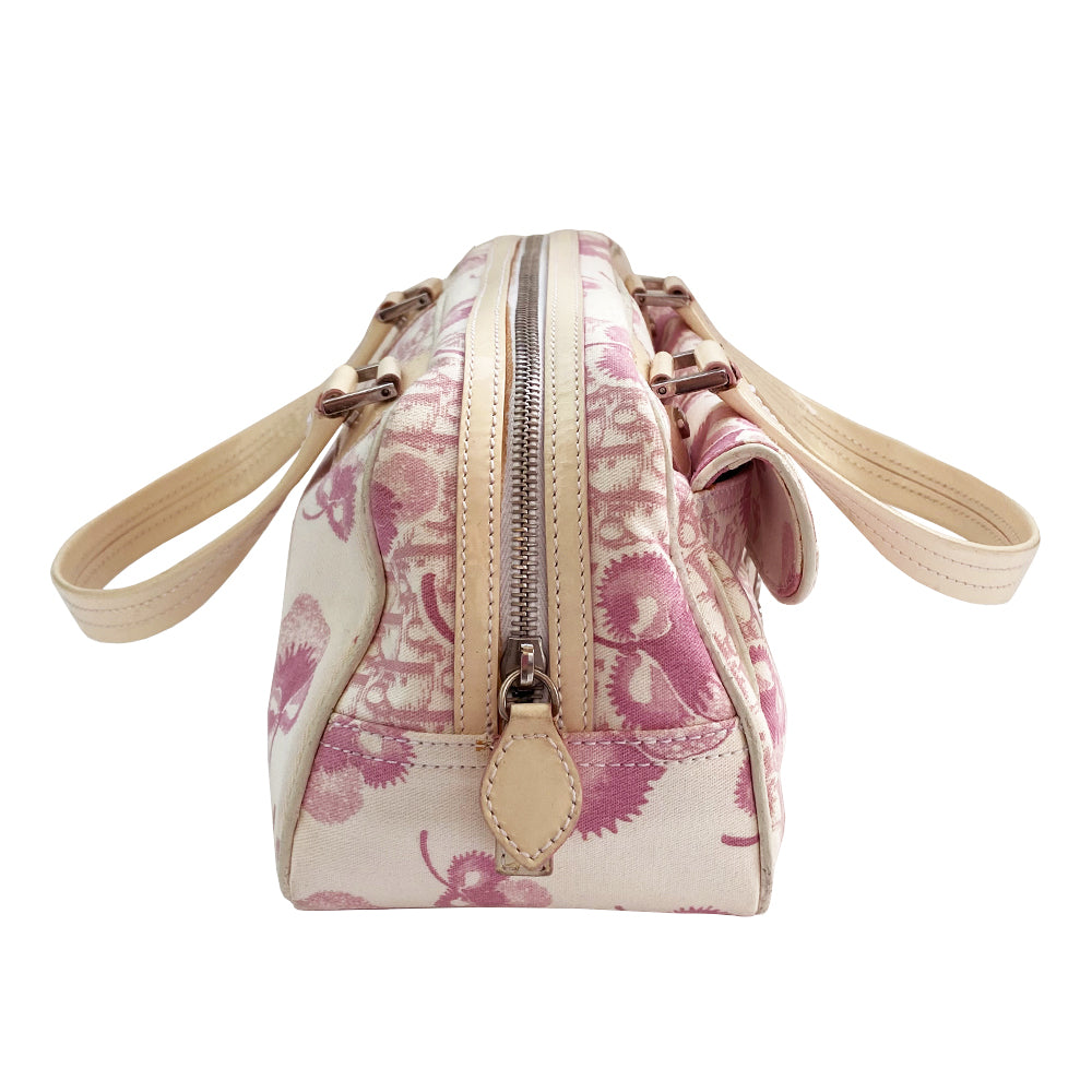Christian Dior cherry blossom boston bag by John Galliano for Dior from 2004 Logo Flowers Collection. Pink flowers and monogram print canvas with patent calfskin handles and accent, silver hardware and zipper. Outside front pocket with Dior logo and front metal loop clasp. Pink with cream patent accent, pink textile interior with single zip pocket.