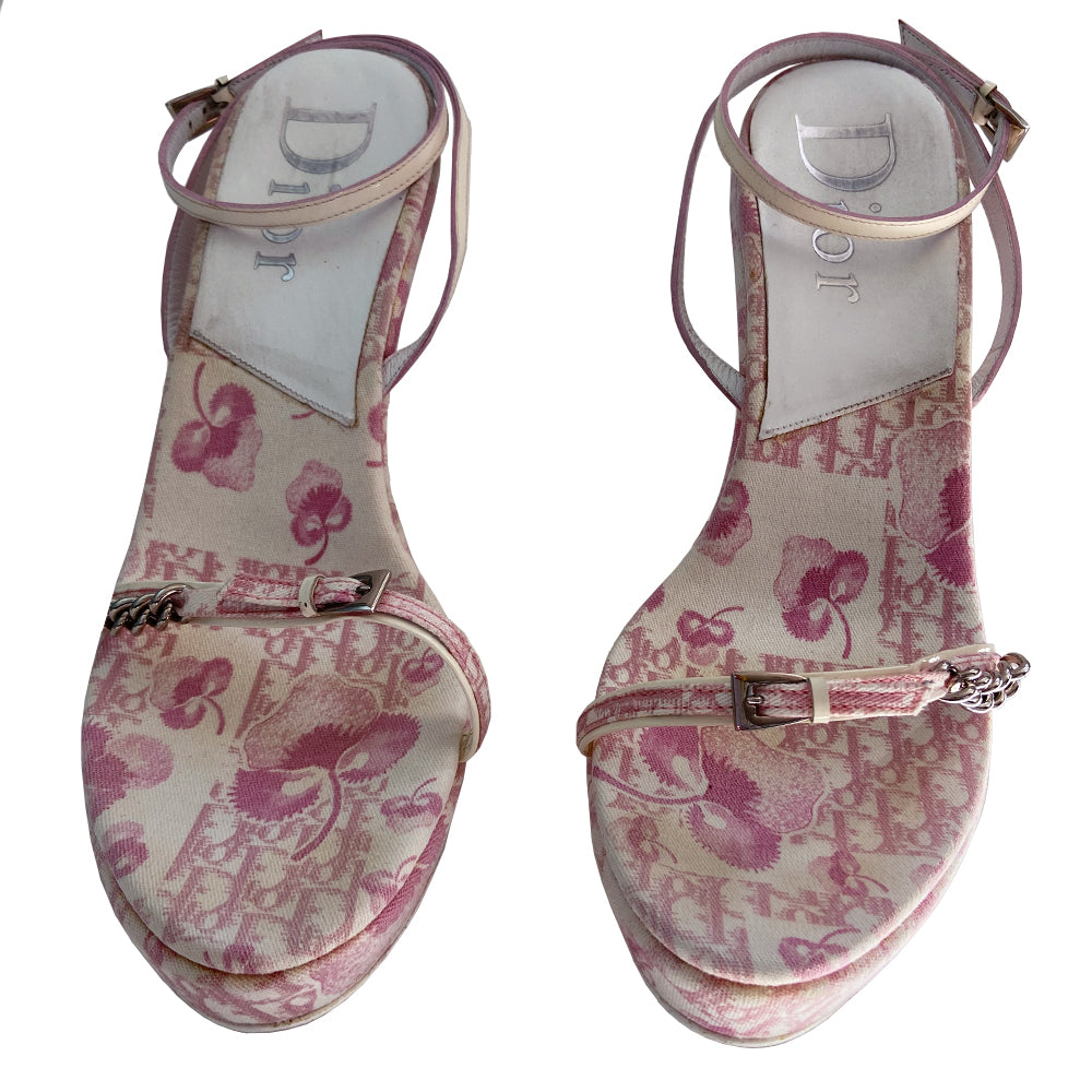 Christian Dior pink cherry blossom monogram on white open toe sandals from John Galliano spring 2003 featuring pink floral monogram with cherry blossom canvas soles, white patent leather heels and wrap around ankle straps. Silver chain and buckle detail layered on upper monogram strap edged with patent leather. Made in Italy