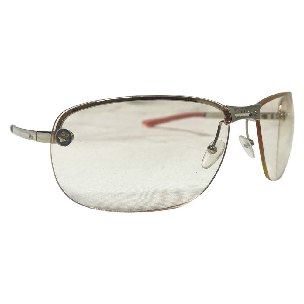 Christian Dior Adiorable 5 clear frameless sunglasses with Curved lens metal frame across upper lens and frameless on the bottom. Gold-tone metal frame with clear blush tinted lenses, Dior engraved logo at nose bridge, star screws at lens outer edges. Style: 3YJIG. Made in Italy