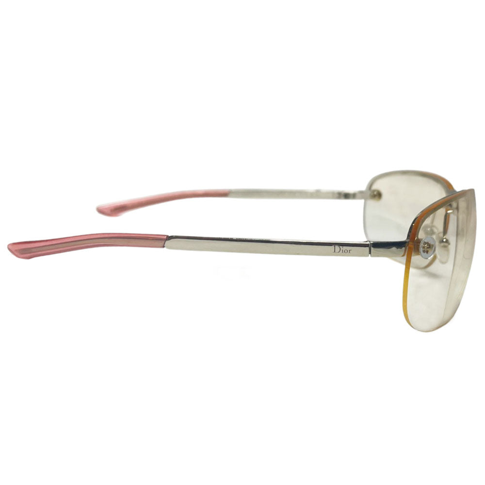 Christian Dior Adiorable 5 clear frameless sunglasses with Curved lens metal frame across upper lens and frameless on the bottom. Gold-tone metal frame with clear blush tinted lenses, Dior engraved logo at nose bridge, star screws at lens outer edges. Style: 3YJIG. Made in Italy