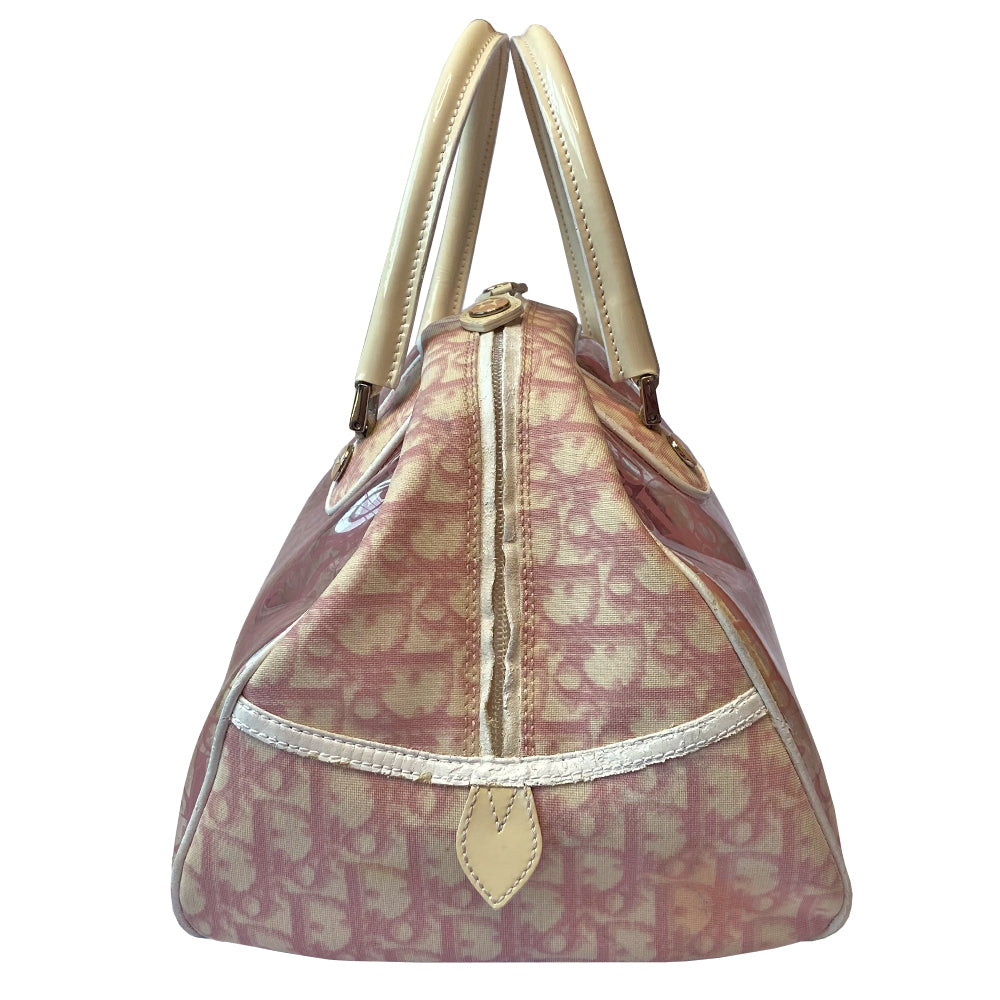 Christian Dior pink monogram Rain bowler bag by John Galliano for Dior, 2004 with transparent vinyl and canvas body, 2 rolled white patent handles and piping, silver-tone hardware, domed bottom feet. Dual zippers opening, roomy pink textile partial lining. Includes pink monogram removable interior pouch. Made in Italy