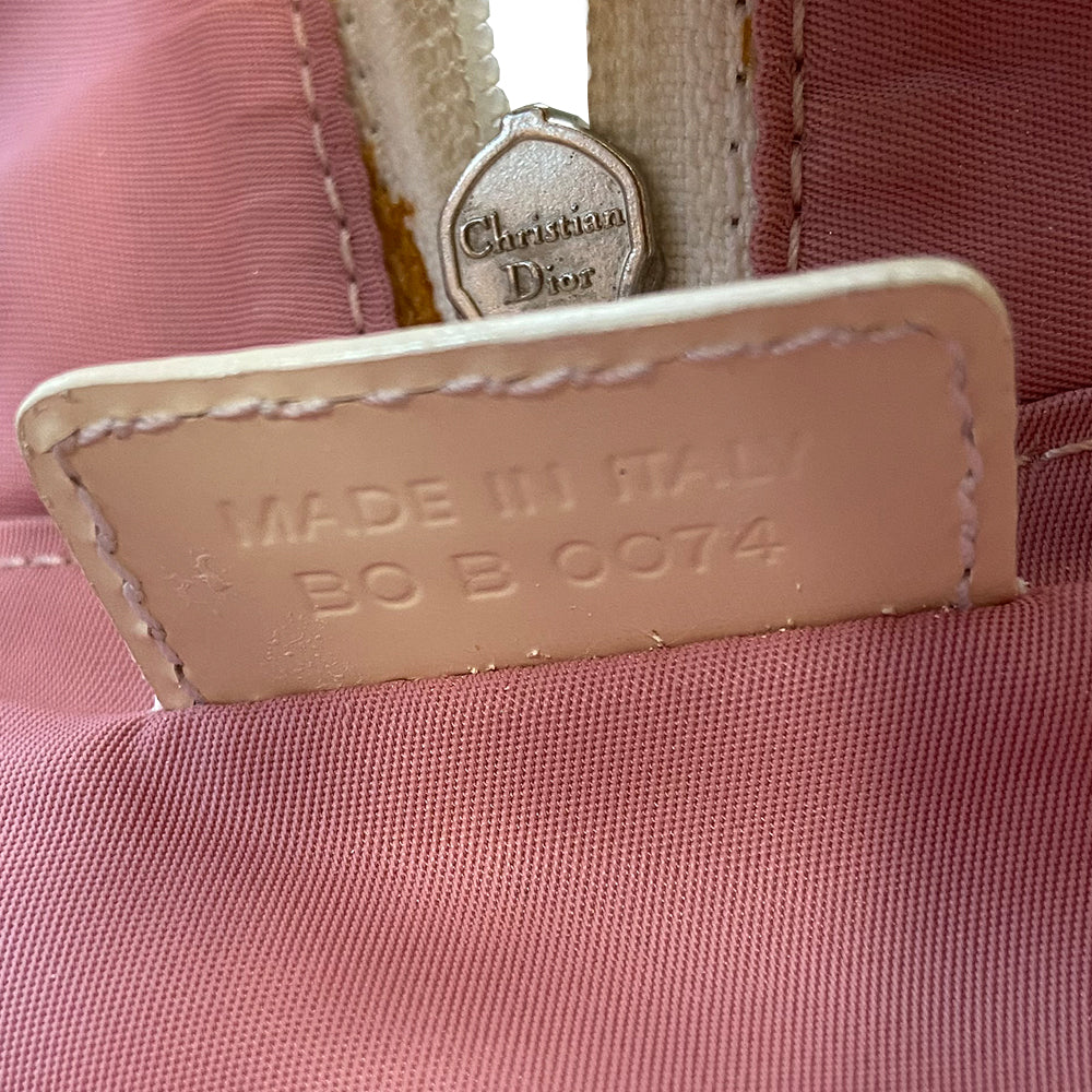 Christian Dior pink monogram Rain bowler bag by John Galliano for Dior, 2004 with transparent vinyl and canvas body, 2 rolled white patent handles and piping, silver-tone hardware, domed bottom feet. Dual zippers opening, roomy pink textile partial lining. Includes pink monogram removable interior pouch. Made in Italy