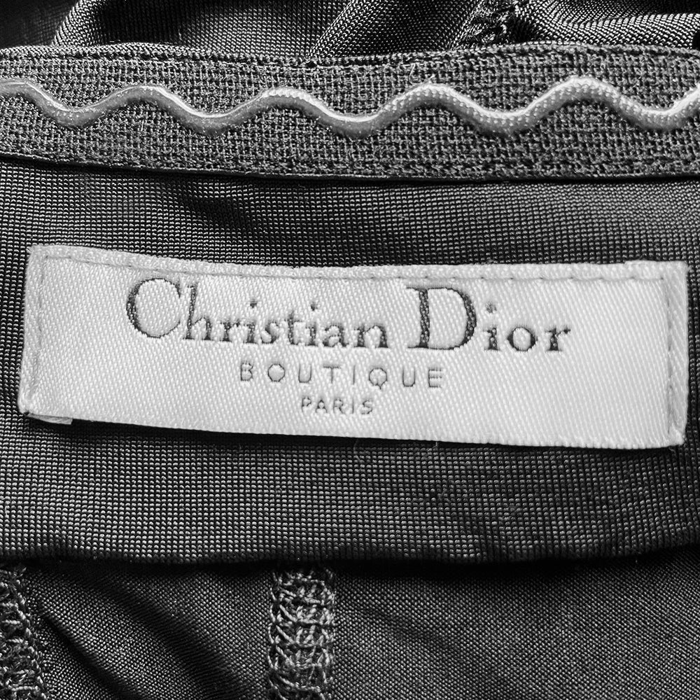 Christian Dior black corset halter dress by John Galliano for Dior, summer 2004. Dior engraved buckle and star adornment on adjustable halter strap attached to laced grommeted bustier, laced grommets at sides, back zipper closure. Made in France