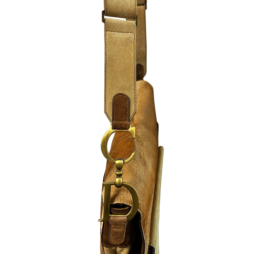 Christian Dior brown, tan, cream pony and suede saddle bag by John Galliano for Dior, 2002. Embossed leather and pony flap with suede front accent, body and shoulder strap, antique brass-tone logo engraved hardware, rear slip pocket, interior jacquard logo lining, zip pocket.