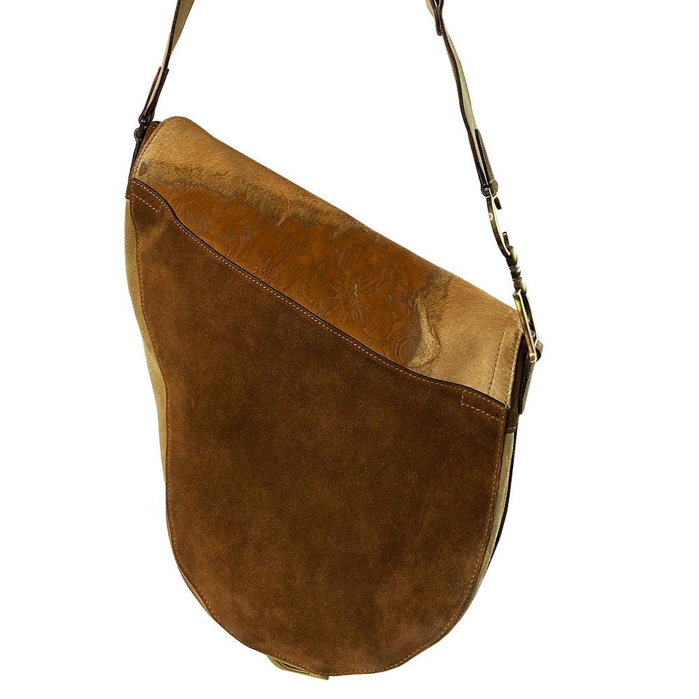 Christian Dior brown, tan, cream pony and suede saddle bag by John Galliano for Dior, 2002. Embossed leather and pony flap with suede front accent, body and shoulder strap, antique brass-tone logo engraved hardware, rear slip pocket, interior jacquard logo lining, zip pocket.
