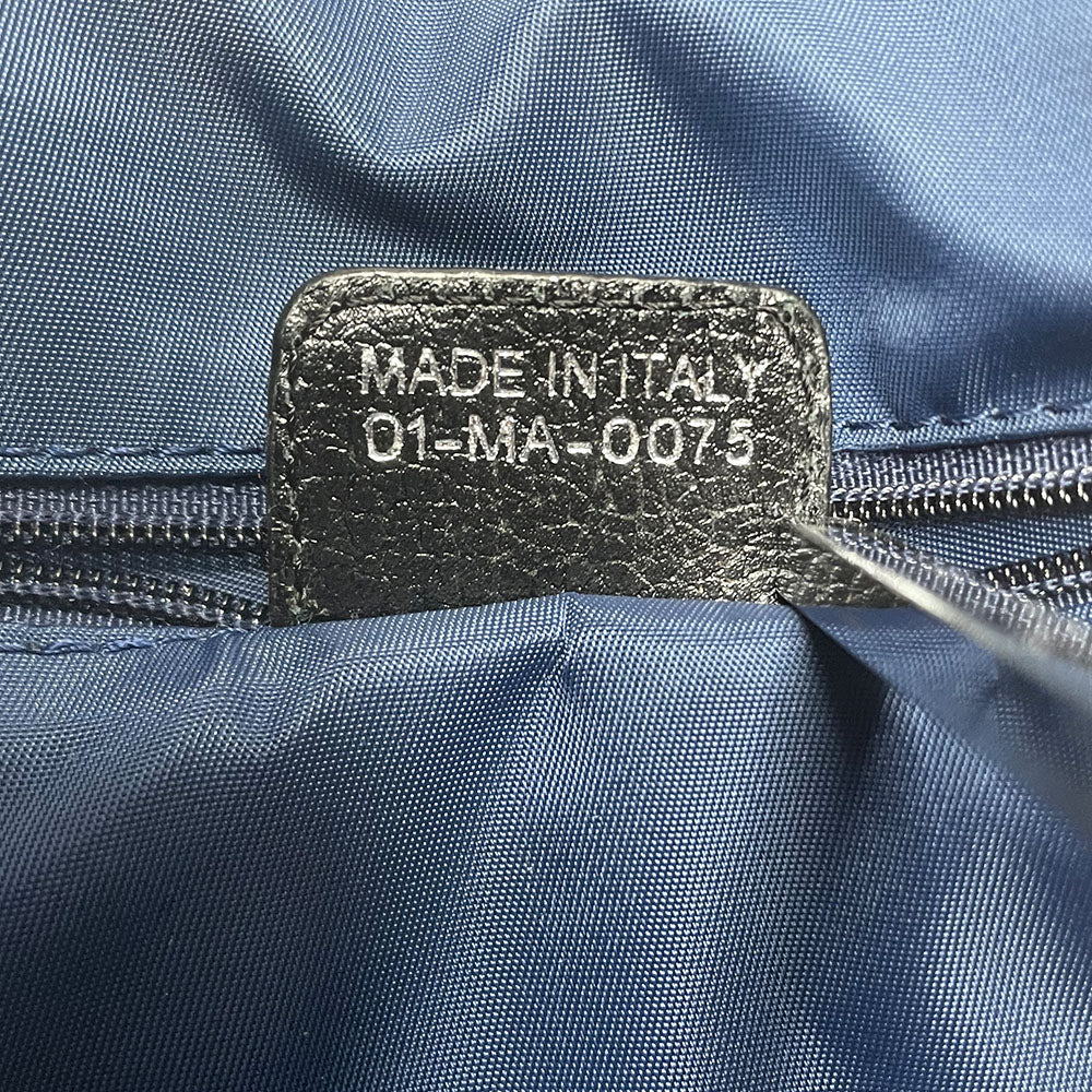 John Galliano for Dior, 2004 navy Diorissimo denim with orange contrast stitching, orange band, silver CD stamped D clasp hardware. Top zip with one interior pocket and navy nylon lining. Made in Italy