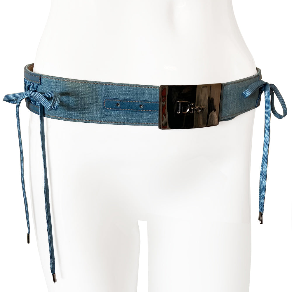 Christian Dior Admit It Denim Lace Up Belt from 2002 runway RTW Collection from John Galliano. Silver-tone rectangular logo buckle with hole adjustments, criss cross lace up detail with blue woven corset laces with silver aglet tipped ends Materials: Denim, Leather Color: Blue Made in France
