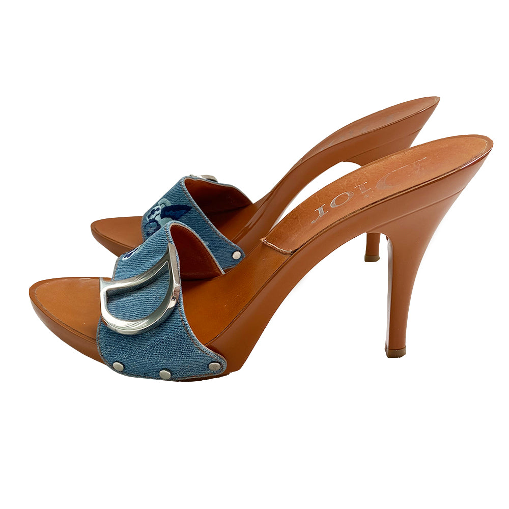 Christian Dior light denim open toe butterfly embroidered slide heels. Denim upper with embroidered butterfly on each shoe in 3 shades of blue, high gloss caramel color platform and soles with embossed rubber grips. Silver-tone logo initial on each shoe, with silver-tone stud attachments at sides. Made in Italy