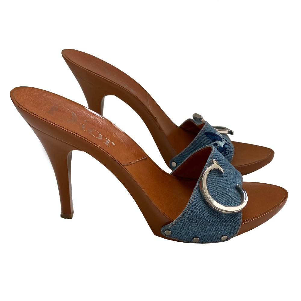 Christian Dior light denim open toe butterfly embroidered slide heels. Denim upper with embroidered butterfly on each shoe in 3 shades of blue, high gloss caramel color platform and soles with embossed rubber grips. Silver-tone logo initial on each shoe, with silver-tone stud attachments at sides. Made in Italy