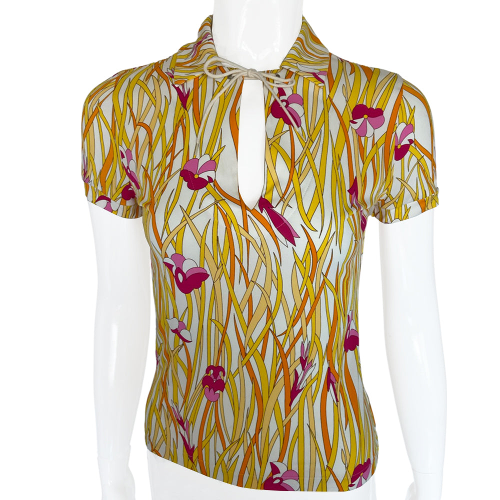 Christian Dior polo top by John Galliano for Dior, spring 2002 with all over long golden yellow intertwined leaf pattern and pink flowers. Open deep V neck with tie cord at neck. Made in France