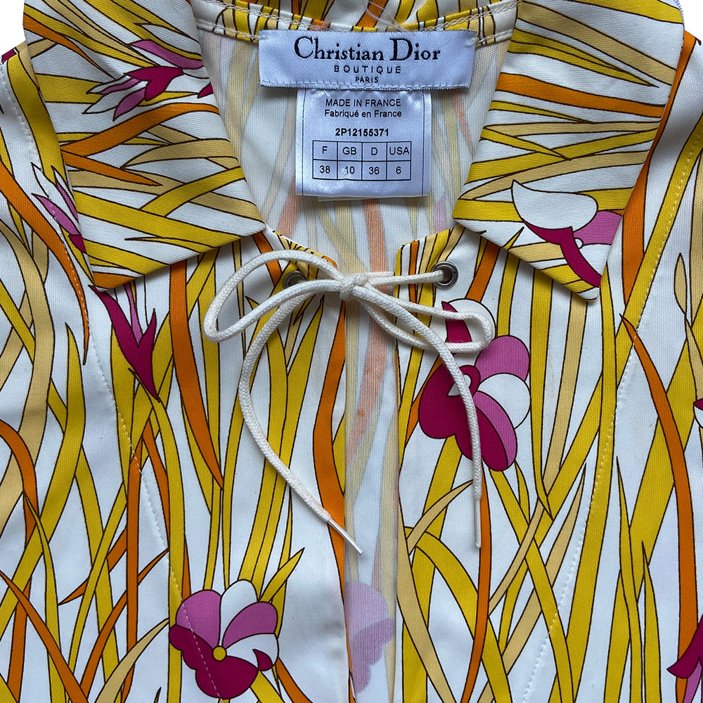 Christian Dior polo top by John Galliano for Dior, spring 2002 with all over long golden yellow intertwined leaf pattern and pink flowers. Open deep V neck with tie cord at neck. Made in France