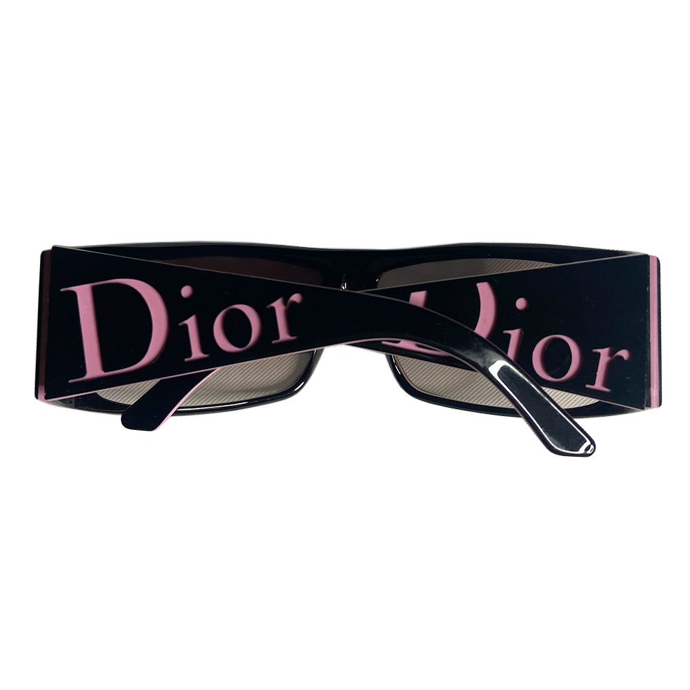 Christian Dior Your Dior 1 sunglasses with black wrap frame and embedded pink pinstripe, wide arms and pink Dior logo embossed at each, grey gradient lenses. Made in Italy