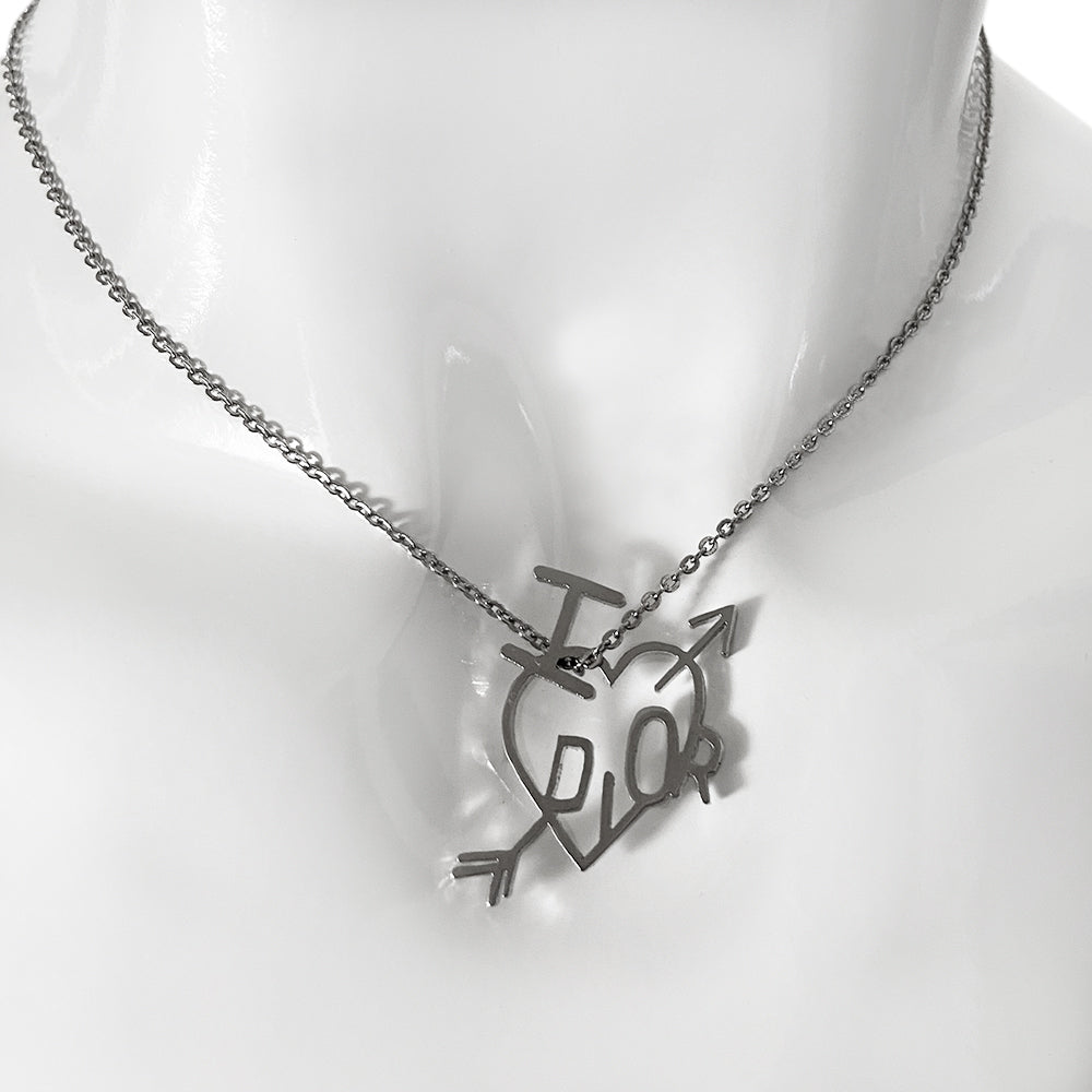 Christian Dior Heart and Arrow silver-tone necklace by John Galliano for Dior, circa 2004 with adjustable chain and hanging charm featuring the signature I heart Dior symbols with piercing arrow. 4 square loops adjust the length with tiny hanging engraved Dior logo D in back