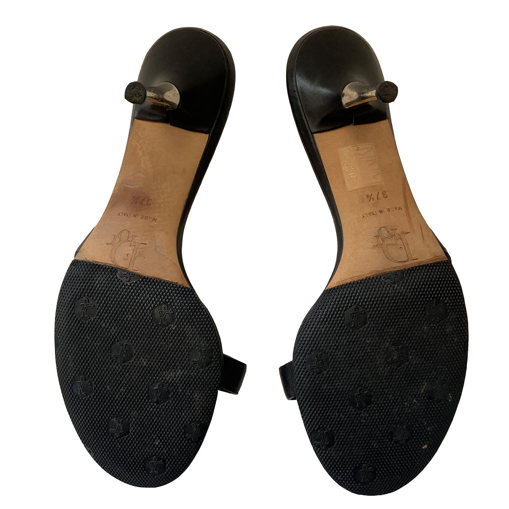 Christian Dior black leather slip-on open toe sandals with silver-tone metal high heels, John Galliano for Dior Spring 2003 with skull, Dior logo and 25% off badges attached to upper leather straps. Leather with silver-tone stud tufting inside front insole. Black with green, yellow, red, white buttons. Made in Italy