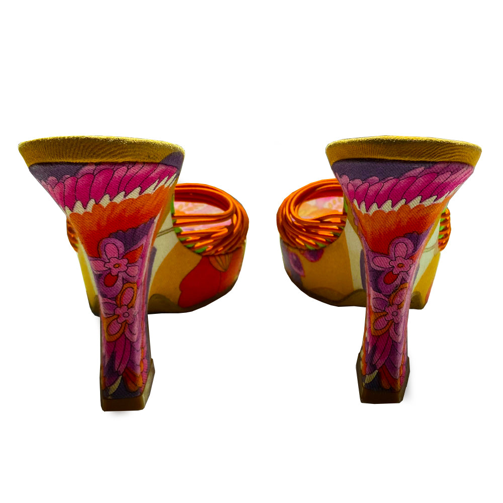 Christian Dior floral wedge platform slides circa 2002 by John Galliano for Dior. Brilliant multicolor floral fabric slip on style with 1” platform, wedge heels, leather soles and bright orange leather Dior logo insole. Multiple orange elastic cord strap upper gathered together with top knot accent. Made in Italy