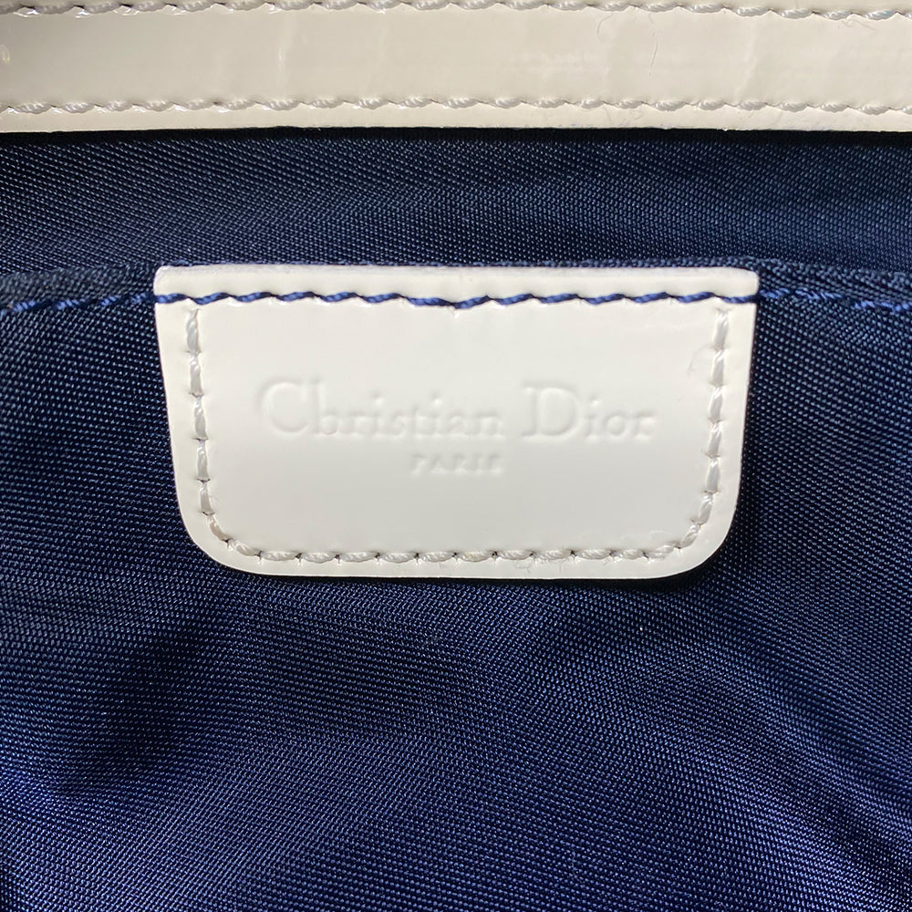 John Galliano for Dior, 2002 navy monogram canvas large weekender bag with 2 outer zip end pouches, velcro rear pocket, white patent leather piping, zipper pulls, No 1 appliqué in front and 2 accent stripes in front. Double canvas handles, detachable, adjustable navy carry strap. Silver-tone zipper and hardware, navy nylon lining with zippered pocket, two snap slip pockets, 3 open pouch pockets. Made in Italy