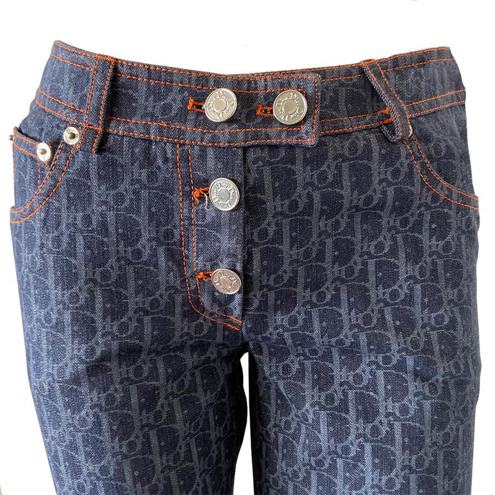 Christian Dior Flight Collection monogram indigo blue denim pants from John Galliano for Dior 2005 collection. Mid-rise 5 pocket Diorissimo print denim with orange accent stitching, angled rear pockets with signature D in orange stitching, Dior engraved logo silver rivets and 3 logo button front closure. Silver-one metal engraved Christian Dior CD buttons, orange Dior patch in back. t