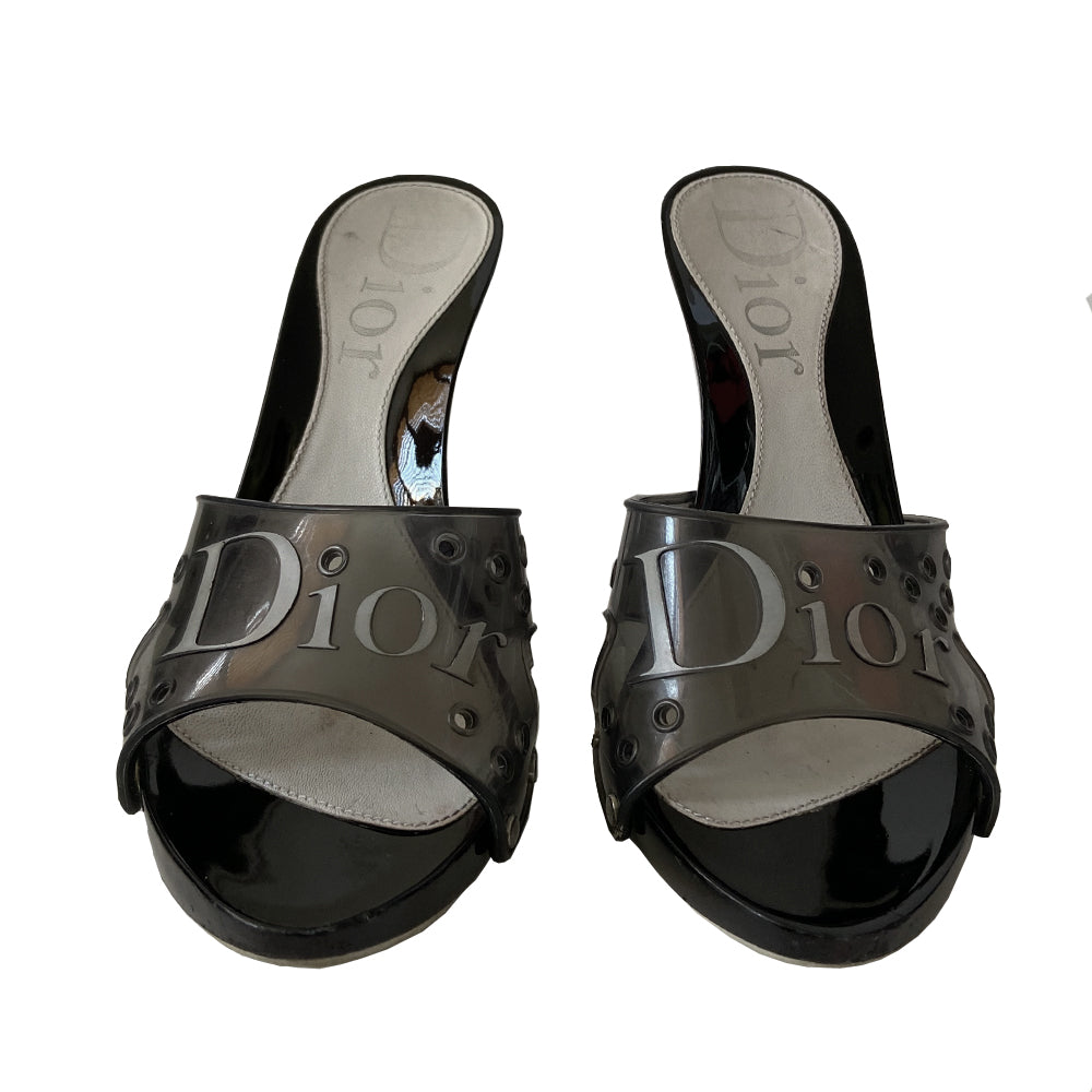 Christian Dior black jelly platform slides by John Galliano for Christian Dior circa 2000. Silver-tone Dior logo on clear black jelly upper with air holes. Glossy black platform and heels with silver-tone side studs. Leather insole stamped with Dior logo at heel. Rubber DIOR stamped bottom soles. Made in Italy