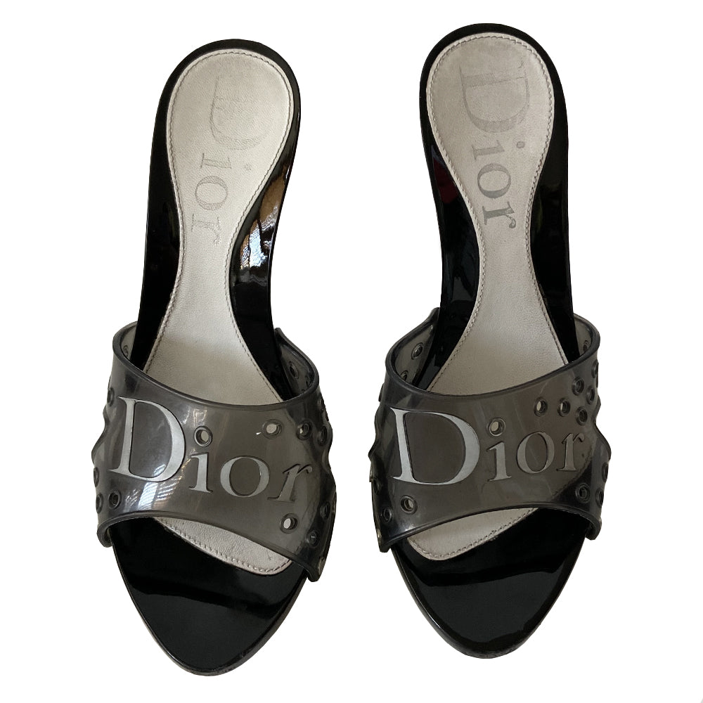 Christian Dior black jelly platform slides by John Galliano for Christian Dior circa 2000. Silver-tone Dior logo on clear black jelly upper with air holes. Glossy black platform and heels with silver-tone side studs. Leather insole stamped with Dior logo at heel. Rubber DIOR stamped bottom soles. Made in Italy