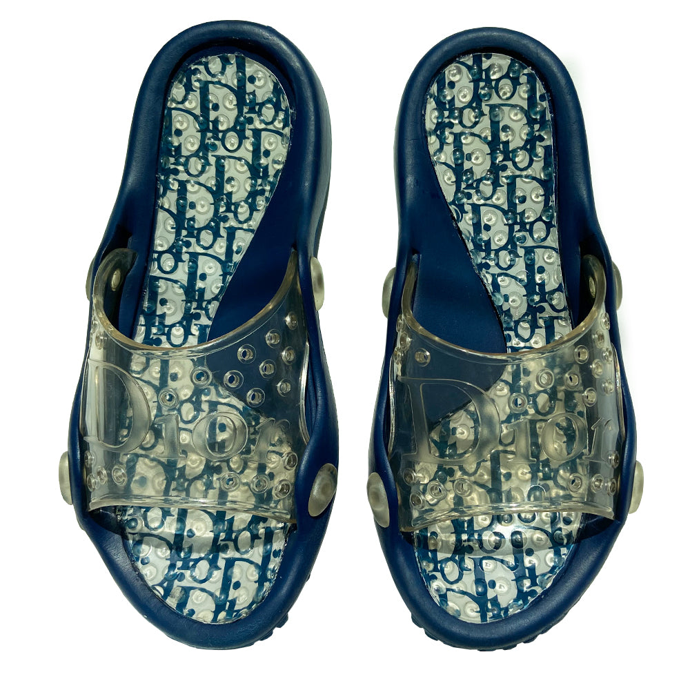 Christian Dior navy blue and white monogram jelly pool slides from John Galliano early 2000’s era. Clear upper with Dior logo embossing and perforated air holes. Monogram insole with clear nubby overlay for added comfort. Rubber bottom sole with grippy nubs and Dior logo imprint. Made in Italy