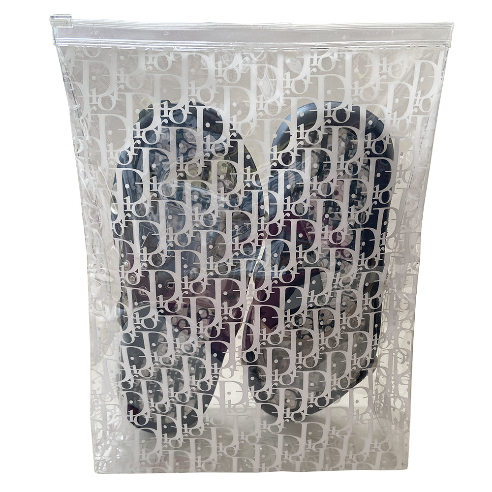 Christian Dior monogram navy on white blue jelly slides sandals from John Galliano early 2000’s era. Dior logo embossed clear upper with perforated air holes. Monogram insole with clear nubby overlay. Rubber bottom sole with Dior logo imprint. Original clear plastic Diorissimo print storage bag included. Made in Italy