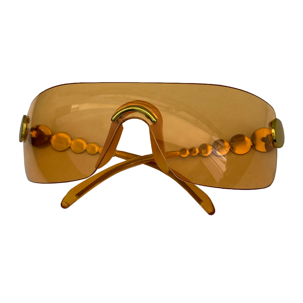 Christian Dior orange millennium sunglasses from 2001. Oversized shield lens with gold-tone hardware Dior logo engraved on arms. Excellent condition with no scratches on lens. Made in Austria.