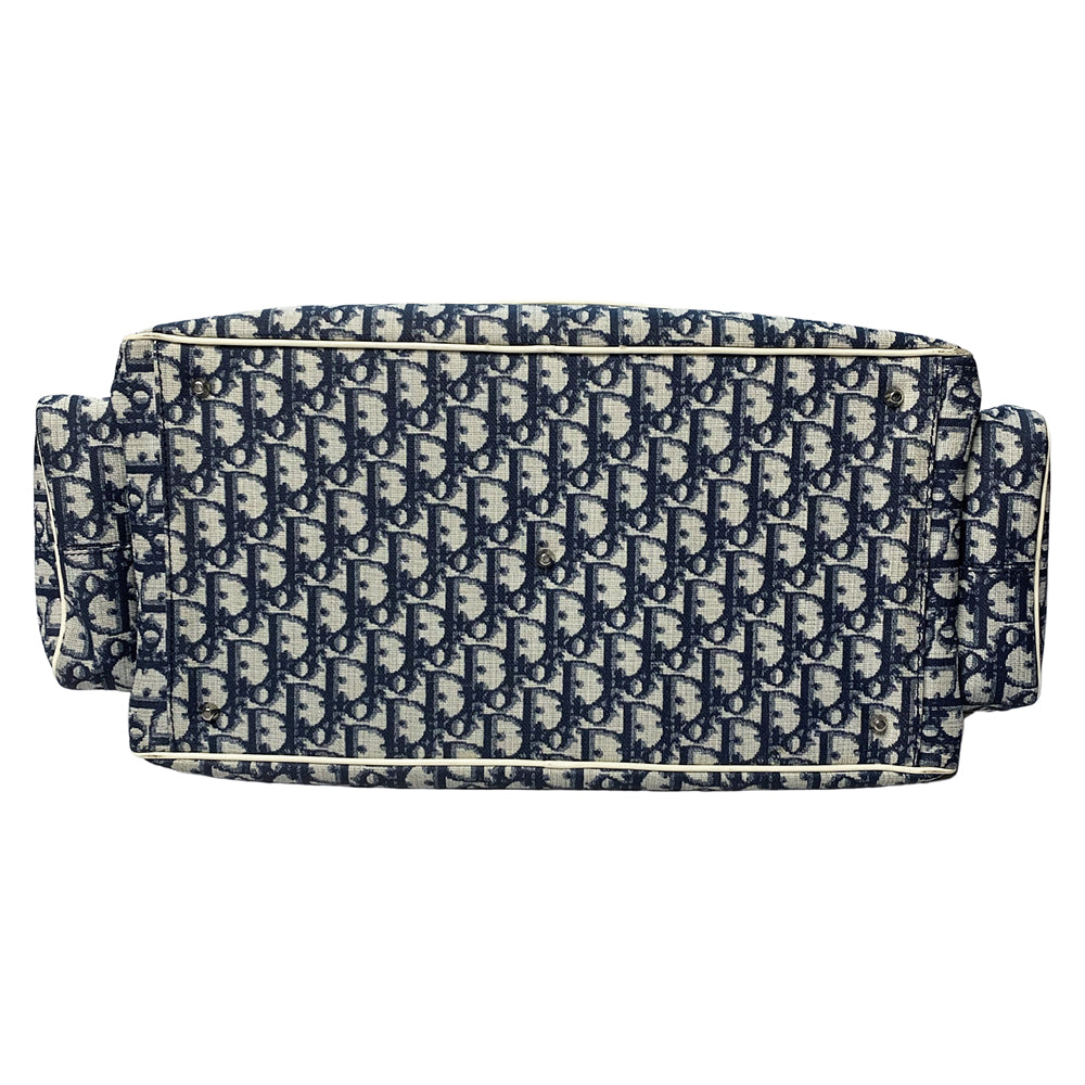 John Galliano for Dior, 2002 navy monogram canvas large weekender bag with 2 outer zip end pouches, velcro rear pocket, white patent leather piping, zipper pulls, No 1 appliqué in front and 2 accent stripes in front. Double canvas handles, detachable, adjustable navy carry strap. Silver-tone zipper and hardware, navy nylon lining with zippered pocket, two snap slip pockets, 3 open pouch pockets. Made in Italy